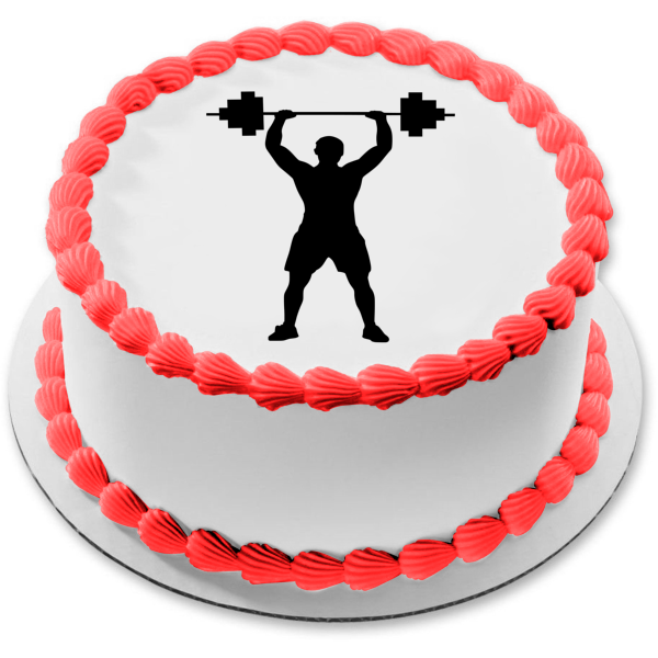 Bodybuilder lifting birthday cake in gymnasium